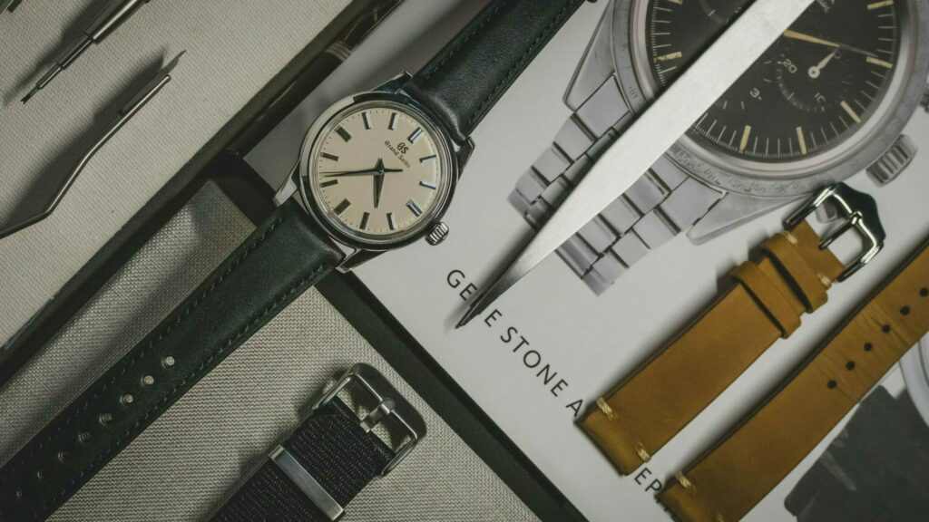 Grand Seiko mounted on a black leather watch band with a nato strap and brown leather watch strap
