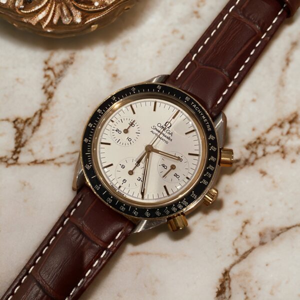 Omega Speedmaster mounted on brown crocodile leather strap with white stitching